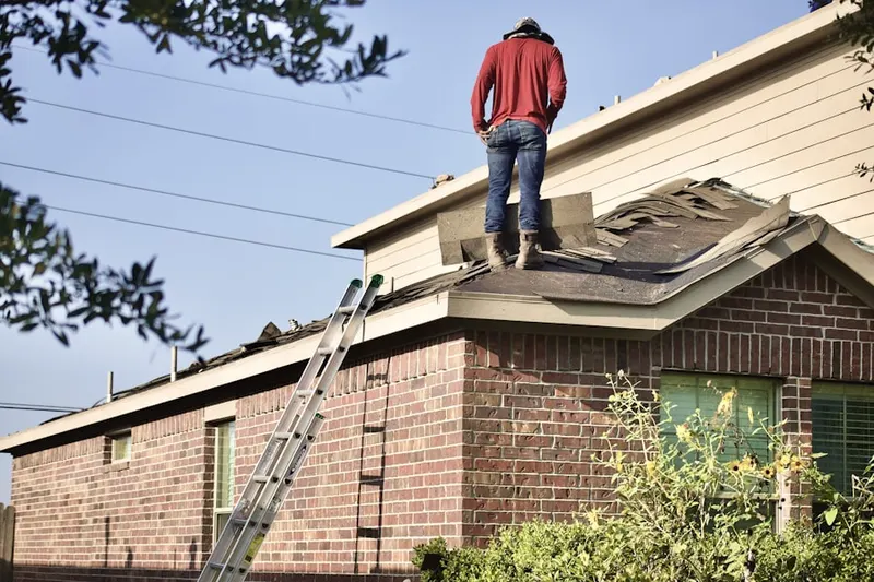 Professional roofer working on a residential roof in Lawrence Junction